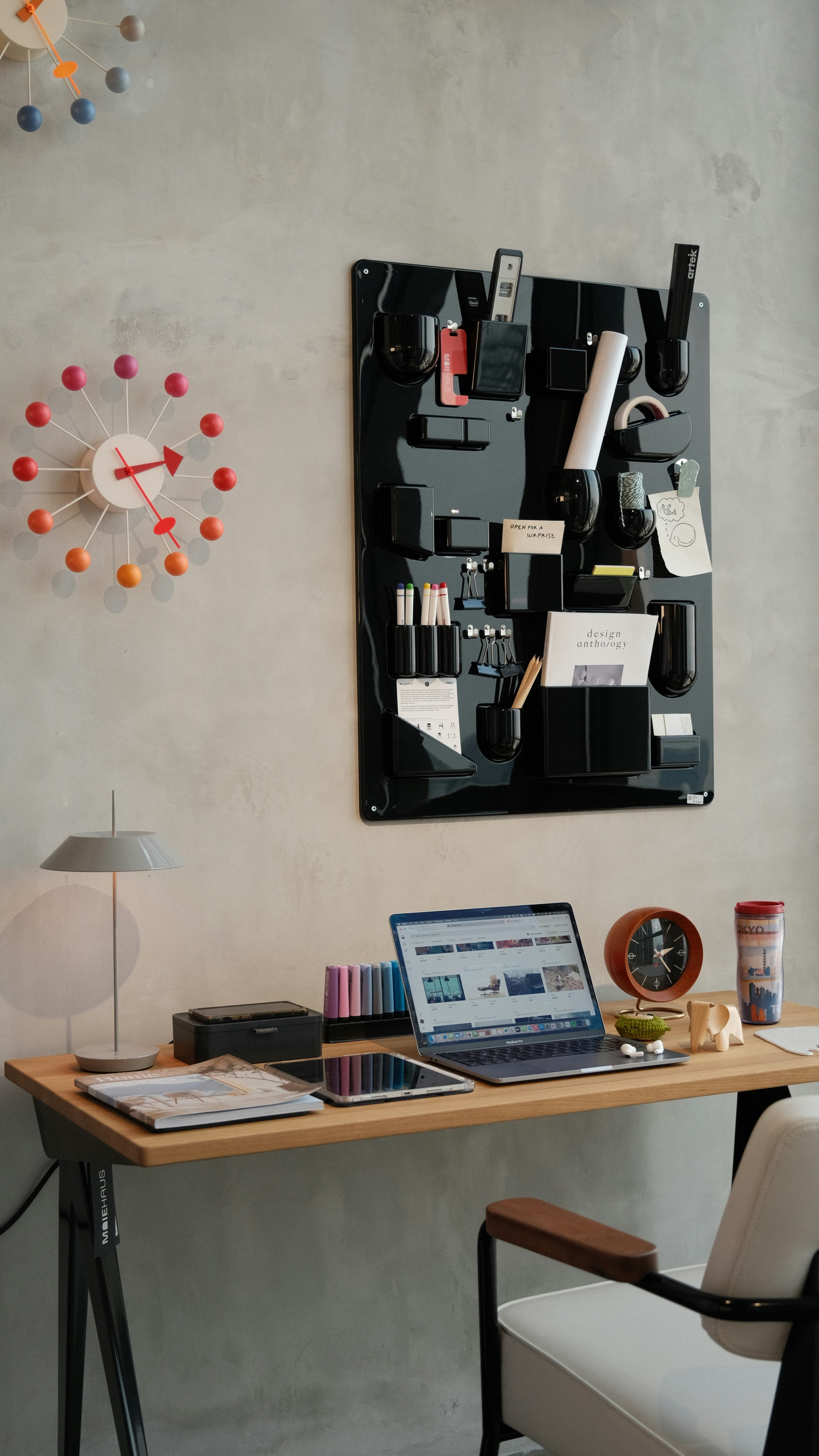 Laptop and desktop monitor showing web and design work